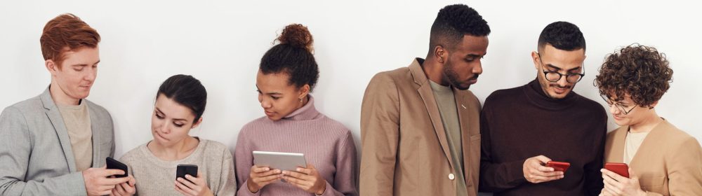 Photo of people standing near white wall